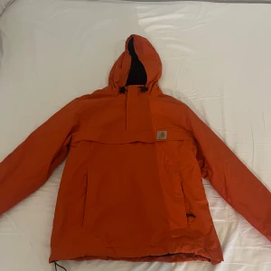 Orange vindjacka från Carhartt WIP - Nimbus pullover från Carhartt WIP. Storlek M/L. Originalpris:1200. Mycket gott skick