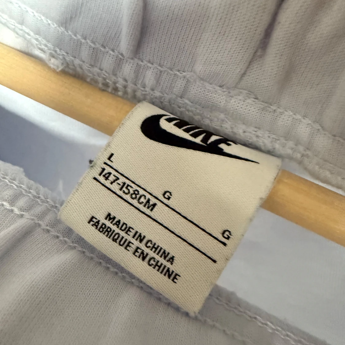 Ljusgrå/vita Nike Tech byxor - 1