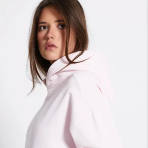 Ljusrosa hoodie  - Supermjuk ljusrosa hoodie med huva och känguruficka. Oversized passform och långa ärmar gör den extra chill. Perfekt för dig som gillar en enkel och clean look. 