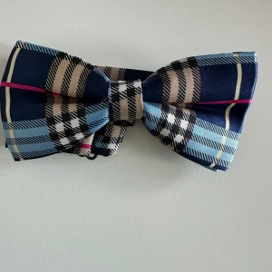 Ny mönstrad fluga - Superfin mönstrad blå-beige / flerfärgad fluga med justerbart band. Ny i förpackning. Perfekt för den som behöver styra upp sig lite i livet.   Hämtas i Stockholm eller skickas mot porto. 