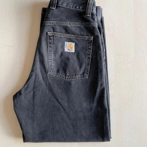 Carhartt Brandon jeans - Tjena! Säljer ett par svarta Carhartt Brandon jeans i storlek S. Väldigt bra skick, använda ca 12 gånger och tvättade ca 3 gånger på fintvätt. Skicket är 8-9/10 enligt mig. Inga fläckar eller hål. Baggy passform men inte överdrivet. Jag är 174 cm lång och de passar mig bra, (be om bild). Passar troligen någon som är 162-175 cm beroende på önskad passform och benlängd. Köpte dessa för 1500 och säljer nu dessa för 1079 kr.Priset är inte hugget i sten.  Be om bilder och ställ gärna frågor! MVH Carl