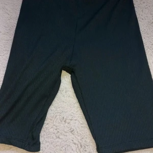 Svarta ribbade shorts - Säljer ett par svarta ribbade shorts med en bekväm passform. Perfekta för en avslappnad stil. De har en elastisk midja för extra komfort.