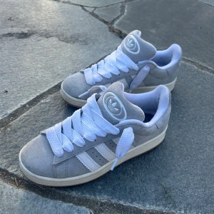 Grå Adidas Campus sneakers - Säljer ett par gråa Adidas campus då de är lite för små, kan gå med på byten men säljer helst. De är helt nya, bara testat ett få antal gånger, de kanske är lite smutsiga men de är som nya. Lådan sparade jag inte. Pris kan diskuteras!