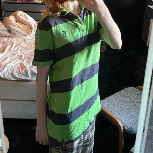 Grön randig piké - Grön och svart pikétröja från Abercrombe & Fitch <3 Det står XXL men det tycker jag är lite att ta i, så stor är den inte.