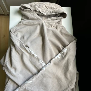 Beige hoodie med tryck på ärmen - Fint skick!