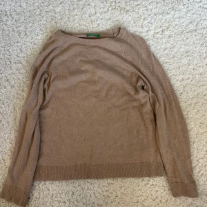Beige cashmere  tröja Benetton - Säljer en enkel och snygg beige cashmere tröja från Benetton. Tröjan har rund hals, långa ärmar och ribbade muddar vid ärmslut och nederkant. Perfekt att slänga på sig när det är lite kyligt ute. Sjukt snygg brun/beige höstfärg!