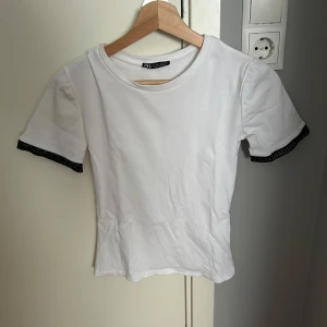 Vit topp Zara - Säljer en vit topp från Zara med rund hals och korta ärmar. Toppen är i storlek S, helt oanvänd. Den är för liten för mig, därför har jag ingen bild hur den sitter på💕💕