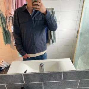 Mörkblå overshirt från Jack & Jones - Säljer en stilren mörkblå overshirt från Jack & Jones. Tröjan är använd fåtal gånger men är i väldigt gott skick👏 Perfekt att bära öppen eller stängd över en t-shirt💁