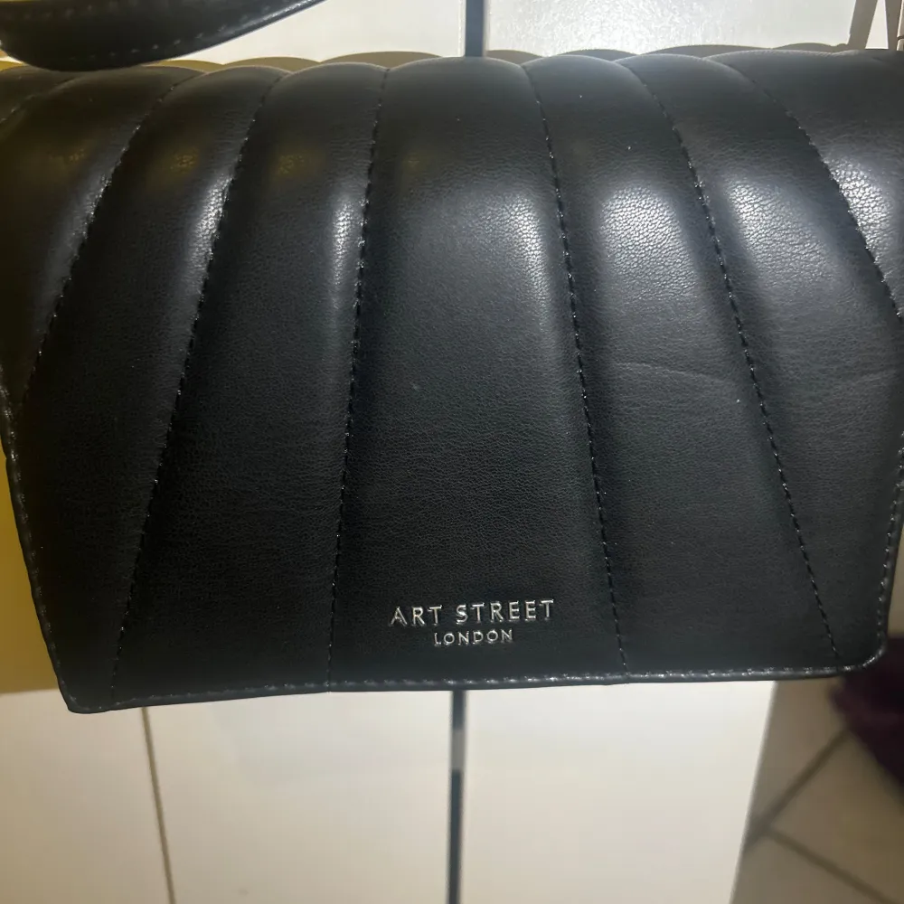 Snygg svart axelväska från Art Street London med quiltad design. Perfekt för att bära dina nödvändigheter med stil. Väskan har en justerbar rem för bekväm användning. Pris kan diskuteras☺️☺️. Laukut & Käsilaukut.