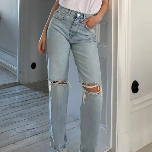 ripped striaght Ljusa jeans storlek 34 - Snygga ljusblå jeans med slitningar vid knäna. De har en hög midja och en rak passform helt ny prislapp på storlek 34 inga defekter