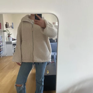 Beige teddyjacka från H&M - Mysig beige teddyjacka från H&M med dragkedja framtill. Jättefin och trendig Teddy jacka. Storlek M.                                 Bra skick och tvättad. Förutom lite missfärgning nere till fast inuti jackan så inget som syns när jackan är på. Mest troligen från jeans.                                      Skriv gärna för fler frågor eller funderingar!!🤩priset går att diskuteras vid snabb affär!!❤️