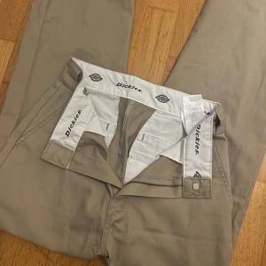 Beige byxor från Dickies - Säljer ett par beige kostym byxor från Dickies. De har en rak passform 