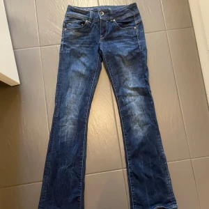 Blå bootcut jeans från G-Star RAW - Hej! Jag säljer dessa snygga jeans från G-star. Dem är lågmidjade och har en cool detalj där back, jeansen är i stretchig material vilket gör dem sköna. Dem har inte använts på länge och därmed säljer jag dem💗