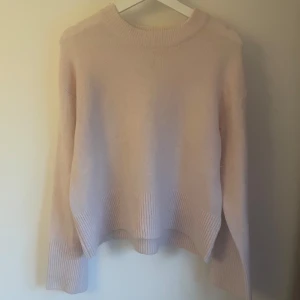 Ljusrosa stickad tröja Gina Tricot - Supermjuk och oversized ljusrosa stickad tröja från Gina Tricot. Tröjan har breda ribbade muddar vid ärmslut och nederkant samt en klassisk rund halsringning. Perfekt för lager-på-lager och chill dagar.