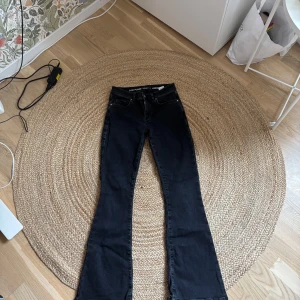 Svarta flare jeans från BikBok - Snygga svarta jeans från BikBok med low flare-modell och låg midja. Byxorna har klassisk femficksdesign, raka ben som slutar i en tydlig utsvängning och är tillverkade i stretchigt jeanstyg för en bekväm passform. Perfekta för dig som gillar retrovibbar och stilren look. Köpta förra året. Använda ett fåtal gånger och prislapp finns kvar ifall man vill ha med den. Pris går att diskutera💗