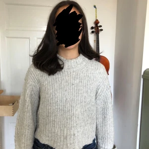 Ljusgrå stickad tröja Gina Tricot - Supermysig ljusgrå stickad tröja från Gina Tricot i grovstickat material. Tröjan har en högre ribbad halsringning och långa ärmar med avslappnad passform. Perfekt att slänga på sig när det är kyligt ute.