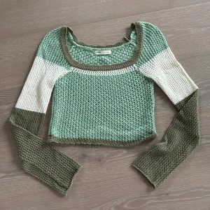 Pull & Bear Croppad virkad tröja i stl M  - Croppad stickad tröja med bred rund halsringning. Perfekt för dig som gillar trendiga och unika plagg med cool struktur.