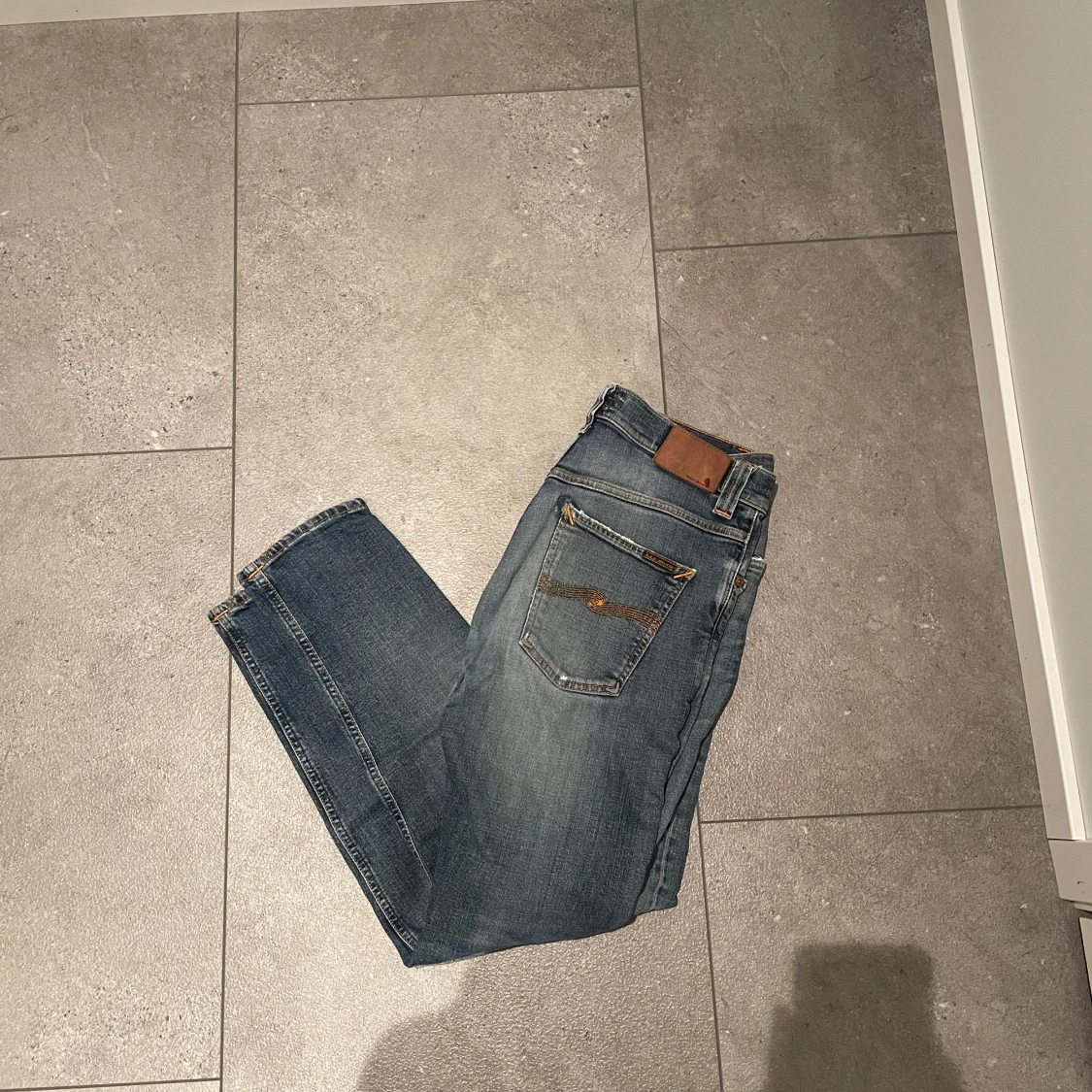 Blå slitna jeans från Nudie Jeans Co
