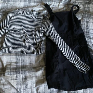 Svart kortklänning från H&M - Säljer en svart kortklänning från H&M i storlek 170. Klänningen har raka axelband och en enkel, stilren design som är lätt att matcha. Materialet känns mjukt och bekvämt mot huden. Perfekt för dig som gillar minimalistisk stil och vill ha en klänning som funkar till många olika looks.