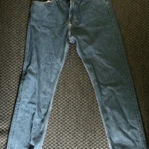 Blå jeans Relaxed fit från H&M - Säljer ett par klassiska blå jeans från H&M i relaxed fit. Jeansen har raka ben, fem fickor och normalhög midja. Perfekta för en avslappnad stil och passar till det mesta.
