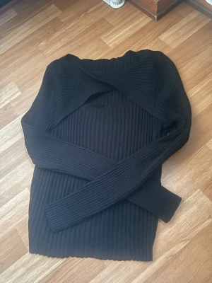 Svart ribbstickad tröja - Säljer en svart ribbstickad tröja med lång ärm och rund hals. Tröjan har en tight passform och är gjord i ett mjukt, stretchigt material som passar perfekt till höst och vinter. Enkel och stilren design som är lätt att matcha.