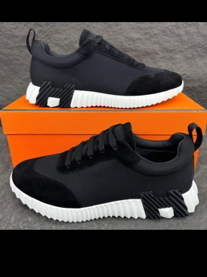 H märkes skor - Stilrena svarta sneakers med vit, räfflad sula och coola detaljer på sidan. Ovandelen är i mesh och mocka för en modern look. Skorna har svarta skosnören och en praktisk hälflik. Perfekta för dig som gillar en clean och sportig stil.