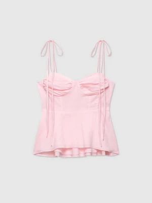 Ljusrosa bustierlinne med knytband - Supersött ljusrosa bustierlinne med tunna axelband som knyts upptill endast testad. Toppen har lätt rynkade kupor och en figurnära passform med något utsvängd nederkant. Perfekt för dig som gillar romantisk och trendig stil. Säljer då den är för liten på mig