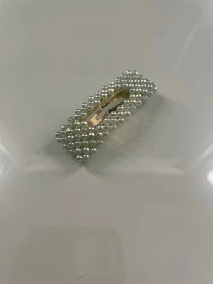 Hårspänne  - Ett hårspänne med en pastellfärg färg 