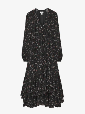 Other Stories Dress Black - En aldrig använd maxiklänning i lätt chiffong. Den har långa, löst sittande ärmar, V-ringning och en elastisk midja som formar sig efter kroppen. Kjolen är lång och luftig med två lager volanger. Passformen är normal, längden är lång och ärmarna är extra långa.  Klänningen är ny och aldrig använd, med prislapp kvar. Storlek: M Längd: 130 cm Midja: 76–80 cm Originalpris: 2200 SEK Pris: 749 SEK