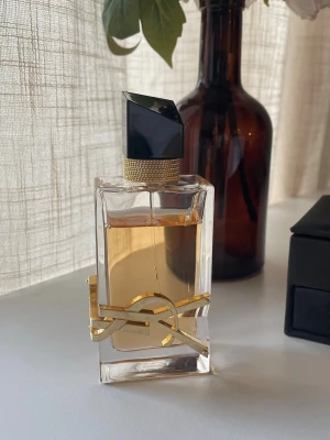 Yves Saint Laurent Libre Eau de Parfum 50ml - Parfym från Yves Saint Laurent, Libre Eau de Parfum 50ml. Toppnoter: Mandarinolja, petit grain-olja, lavandinolja från Frankrike och ett stråk av svarta vinbär. Mellannoter: Lavendelolja, arabisk jasmin, jasmin grandiflorum och essens från apelsinblommor Basnoter: Vaniljextrakt från Madagaskar, cederträolja, ambraackord och mysk. Obs denna parfym är delvis använd med majoriteten kvar.