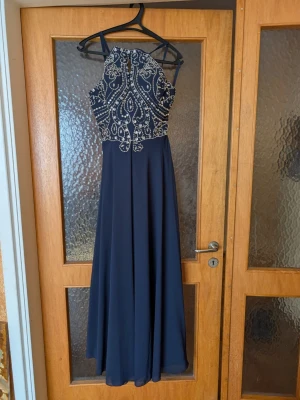 Navy Blue Beaded Prom Dress Hebeos - I’m selling my absolutely gorgeous dress in a deep navy blue because it’s simply too beautiful to just sit in my closet!✨  Fabric: Made of a lightweight flowing chiffon and Inner dress in satin. One of the best things about it is the "hidden" potential for adjustments! If you look at the photos, you can see there’s some extra fabric (seam allowance) at the neck/straps. This means if you need it to sit a bit differently or want a tailor to tweak the length of the bodice, it’s super easy to do.