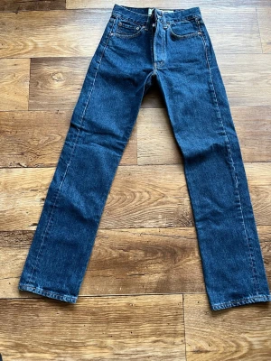 Crocker jeans W27 L30 - Klassiska blå  jeans med rak passform och fem fickor. Jeansen har hög midja, gylf med knappstängning och är tillverkade i slitstark denim. Perfekta för en avslappnad och tidlös stil.
