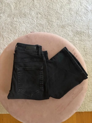 Svarta bootcut jeans Curve XS/32 - Snygga svarta bootcut jeans från Curve i storlek XS/32. Jeansen har något utsvängd passform nertill. Tappat lite färg 