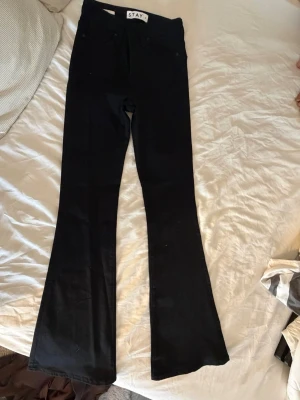 Svarta högmidjade bootcut jeans - Säljer ett par svarta bootcut jeans med hög midja. Storlek xs användt 1 gång pga för små minns ej vart ifrån dom är.