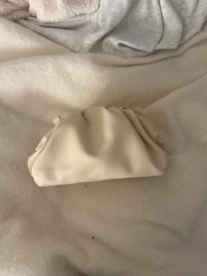 beige clutch väska - man får med ett band nypris: 349kr
