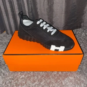 H&M Skor - Säljer ett par stilrena H Bouncing sneakers från H i mycket fint skick. En exklusiv och modern modell med sportig design, perfekt för dig som vill kombinera komfort med lyx.  Skorna är tillverkade i högkvalitativa material och ger en riktigt snygg look till både vardag och mer uppklädda outfits. Väldigt sköna att gå i.  • Storlek: 43 • Färg: Svart med vita detaljer • Skick: Mycket bra, Oanvända • Pris: 2100 kr  Skickas samma arbetsdag! Alltid noggrant paketerad. Hör av dig vid frågor!