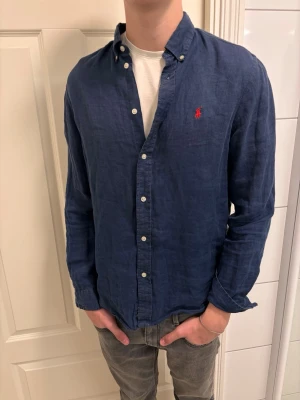 Ralph lauren skjorta -   Säljer en linneskjorta från Ralph Lauren  Storlek: XL (18-20) Fits S Skick: 9/10 Färg: [Marinblå  💰 Pris: 499 kr- Pris går ner vid snabb affär (prioteras)