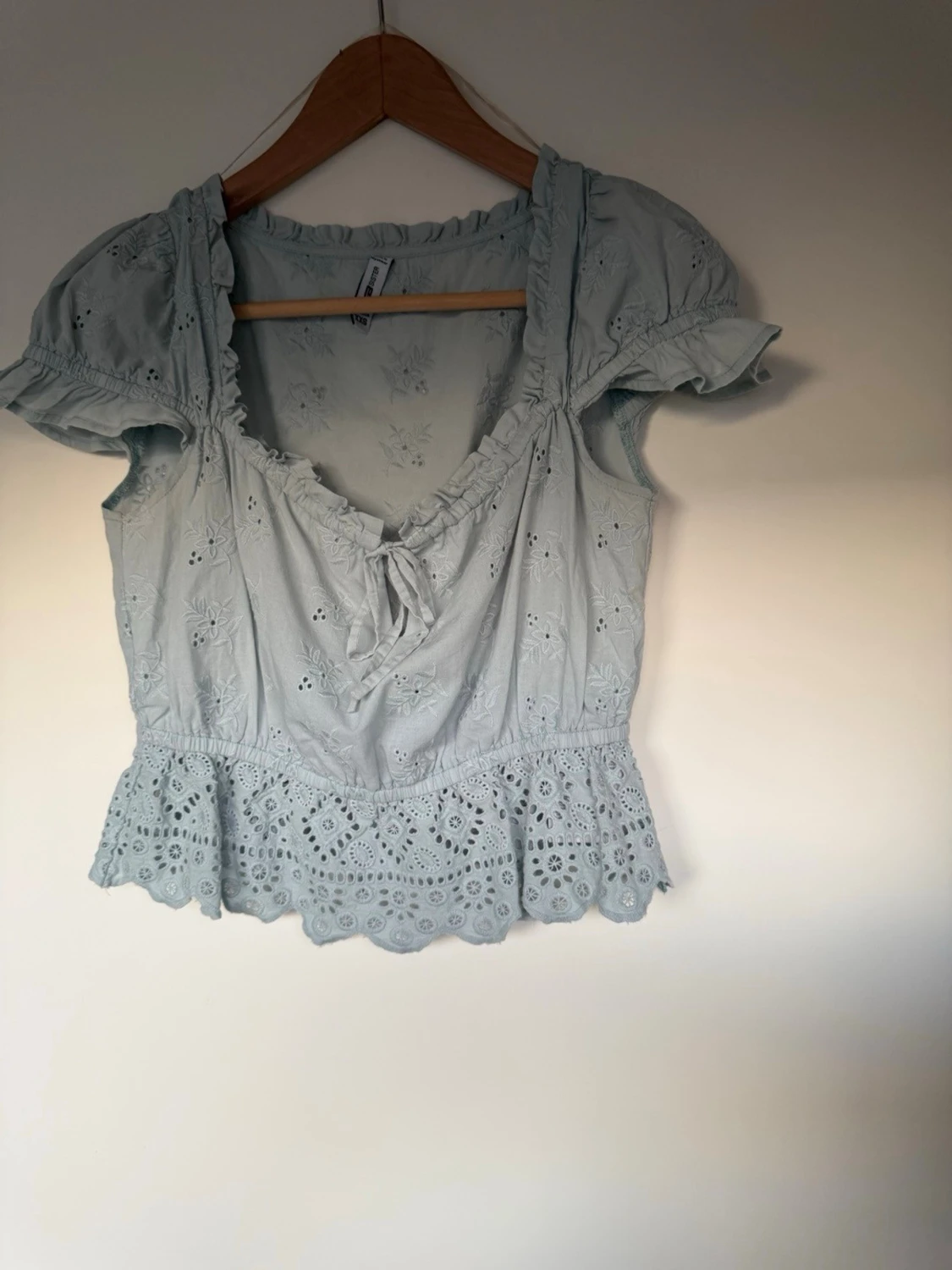 Ljusblå broderad blus med volang