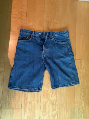 Mörkblå jeansshorts  - Säljer ett par mörkblåa jeansshorts från hm i mycket bra skick, nästan aldrig använda! Storlek 32 sitter som M/L.