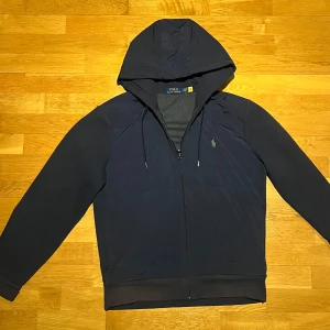 Ralph Lauren cardigan  - Säljer nu en Ralph Lauren cardigan i färgen mörkblå. Den är i bra skick bortsätt från att den börjar bli lite solblekt längst midjan. Storleken är L men skulle säga att den sitter mer som M. Nypriset ligger på 2995 men säljer nu för 799 Det är bara att säga till för fler bilder!!