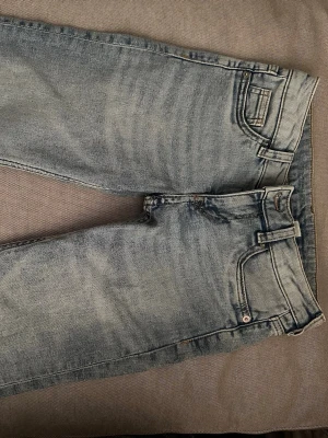 Ljusblå low waist bootcut jeans - Säljer ett par ljusblå low waist bootcut jeans från h&m knappt använda 
