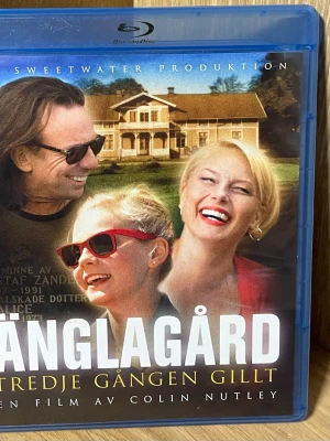 Änglagård Blu-ray film - Säljer Blu-ray-filmen 'Änglagård – Tredje gången gillt', regisserad av Colin Nutley. Svensk film med dramainslag, vacker landsbygdsmiljö och kända skådespelare. Omslaget är blått plastfodral med färgglad framsida och svensk text.
