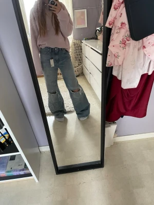Blåa vida jeans med hål på knäna - Berda mid waist jeans som är nya. Storlek xs men känns som storlek s.