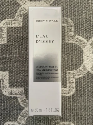 Issey Miyake L'Eau d'Issey roll-on deo - Fräsch roll-on deodorant från Issey Miyake, L'Eau d'Issey. Kommer i en stilren vit och silverfärgad förpackning, 50 ml. Innehåller naturliga ingredienser och har en lätt, elegant doft. Perfekt för dig som gillar exklusiva dofter och enkel applicering.