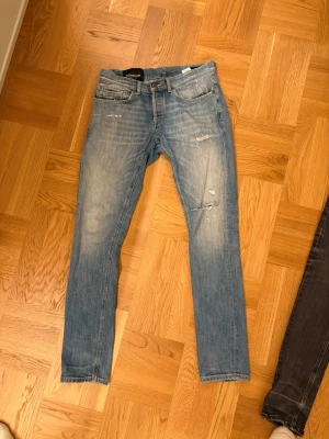 Dondup jeans - Säljer ett par ljusblå skinny jeans från Dondup med slitningar och distressed detaljer på framsidan. Dem är knappt använda och riktigt snygga.