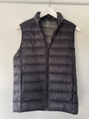 Väst Uniqlo - Säljer en svart dunväst från Uniqlo. I storlek Xs i mycket bra skick.