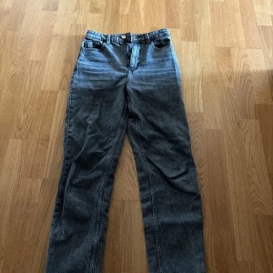 Gråa raka jeans från Zara, stl 34 - Säljer ett par gråa jeans från Zara i storlek 34. Jeansen har hög midja, raka ben. Materialet är denim och färgen är tvättad grå med en lite vintagekänsla. 