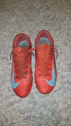 Nike röda fotbollsskor pro stl 40 - Säljer ett par nike röda fotbollskor som sticker ut på planen
