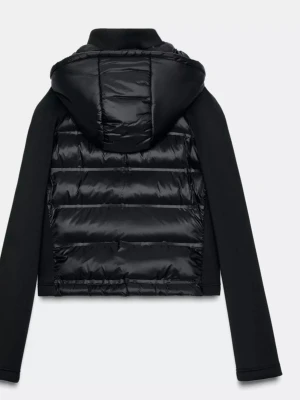 Svart pufferjacka med huva - Snygg svart pufferjacka med huva och dragkedja framtill. Jackan har quiltad front och rygg i glansigt material, medan ärmarna är släta och matta. Perfekt för dig som gillar en sportig och modern look. Croppad passform som ger en cool vibe. 