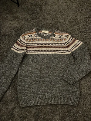 Stickad tröja med mönster  - Riktigt fet stickad crewneck med unikt mönster. För dig som vill stå ut från mångden men ändå vara stilig. Storlek S